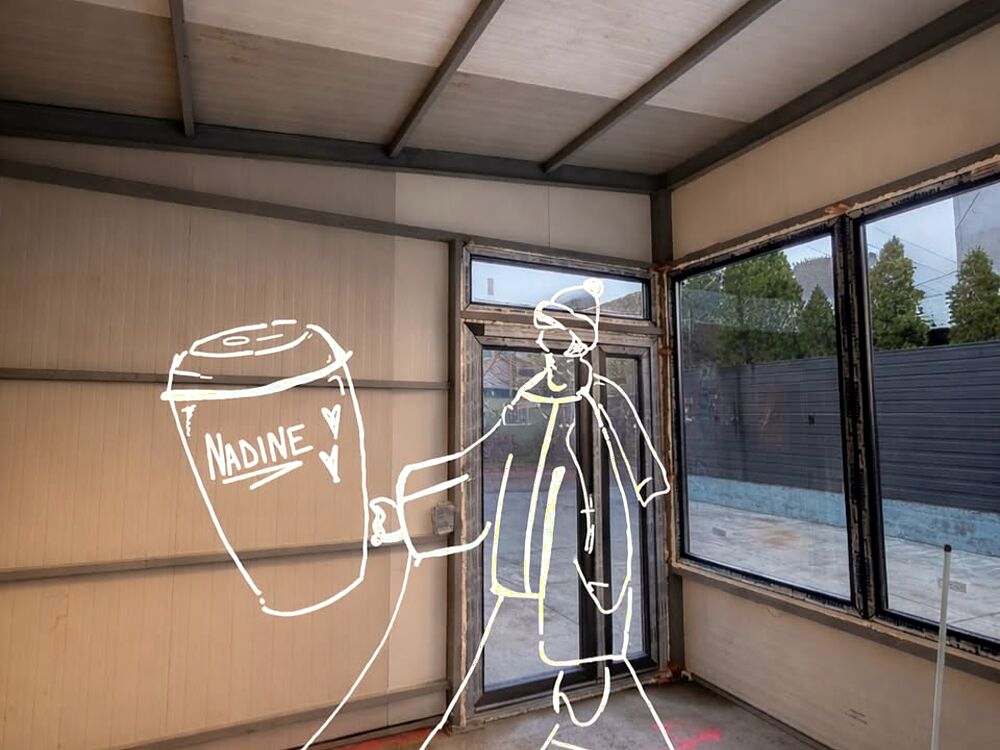 Interiorul spațiului nou, cu schița unui pahar de cafea Nadine desenată peste fotografie